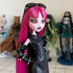 Three-quarter view close-up custom reroot example of Cerise Pink saran doll hair on Monster High Draculaura by @thedolldaddie. Detailed shot showcasing the smooth hair flow, blunt bangs, and dark lowlight contrast against her custom face paint.