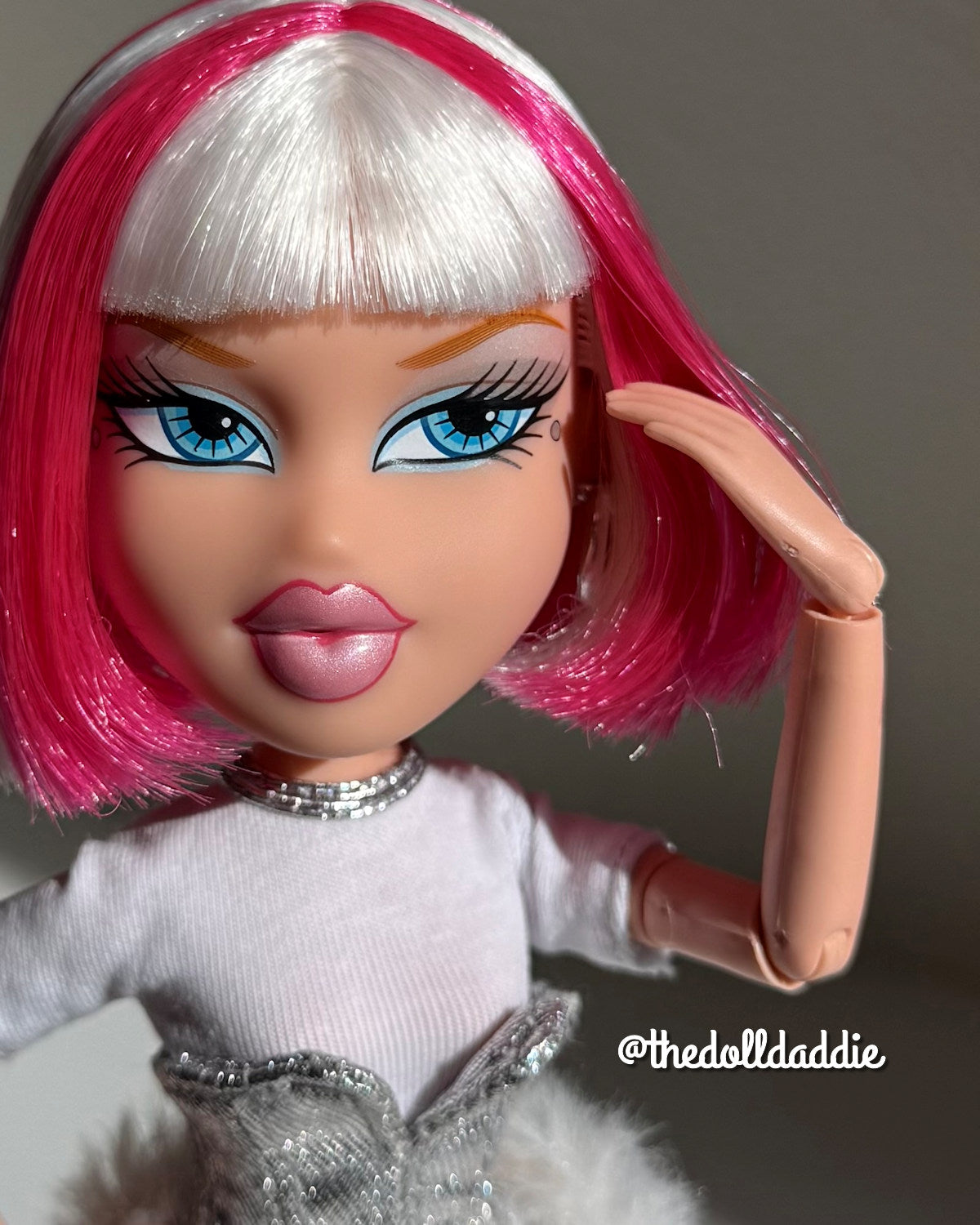 Front close-up of custom Bratz Charmz Cloe with Shimmer Locks Dragonfruit hot pink and Ivory white saran doll hair rerooted by @thedolldaddie. Focuses on the blunt bangs, cheek-length bob finish, and fiber sheen.
