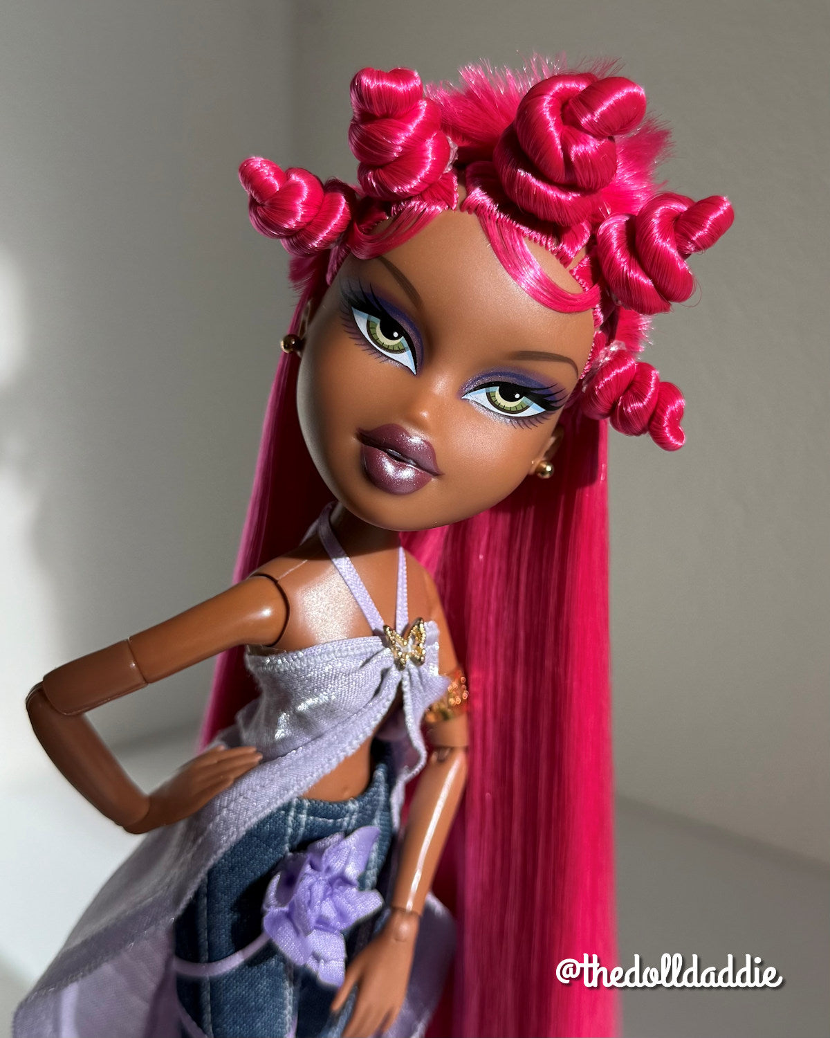 Angled portrait of custom Bratz Pop Starz Sasha rerooted with Dragonfruit hot pink saran doll hair by @thedolldaddie. Shows how direct sunlight hits the fiber.