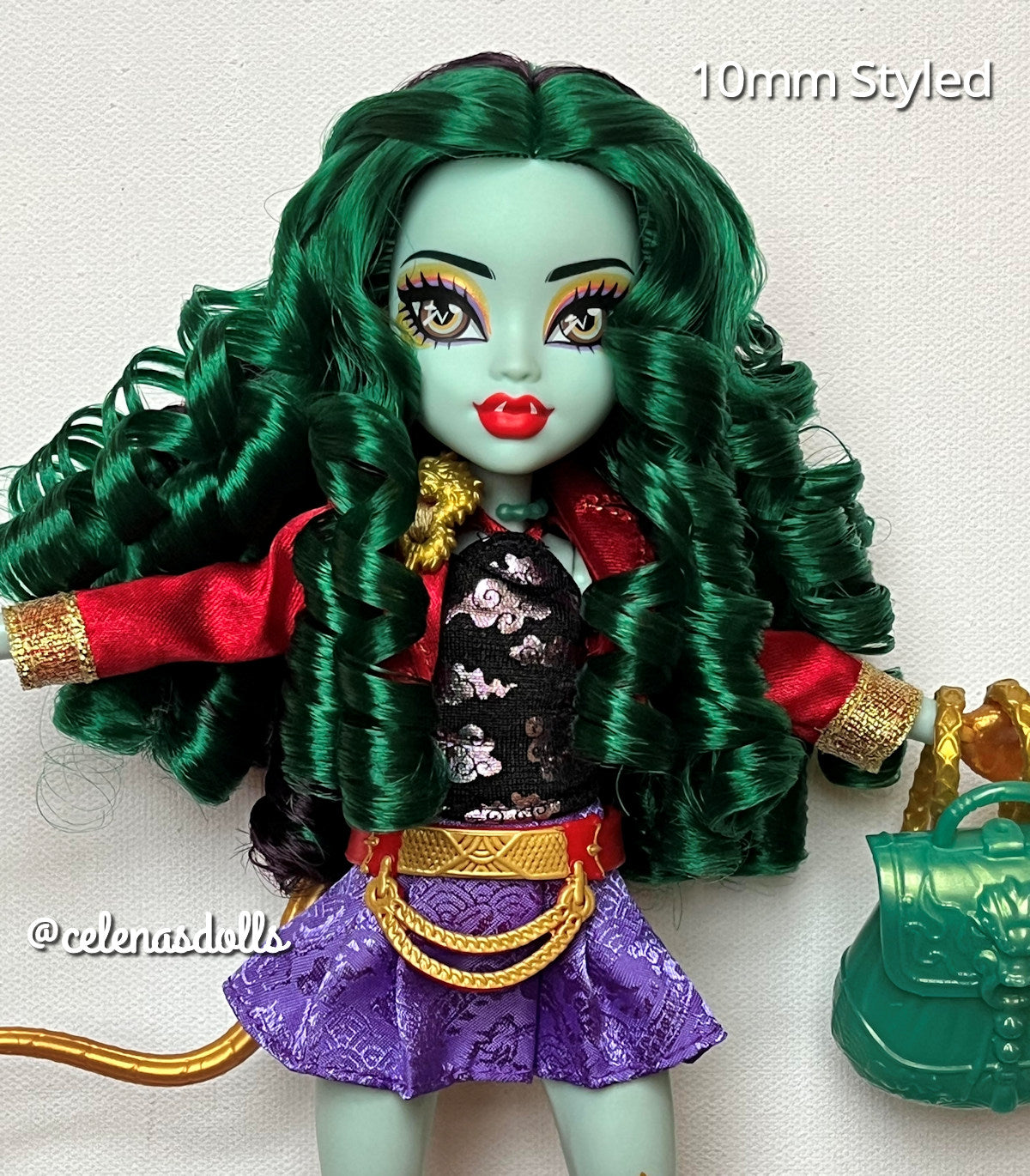 Monster High Jinafire Long doll displaying defined emerald green nylon hair curls from Shimmer Locks and styled with her original outfit and accessories.
