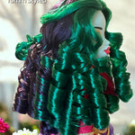 Side profile of a Monster High G3 Jinafire Long doll featuring a custom reroot with emerald green and Dark Embrace purple 10mm curly nylon hair from Shimmer Locks