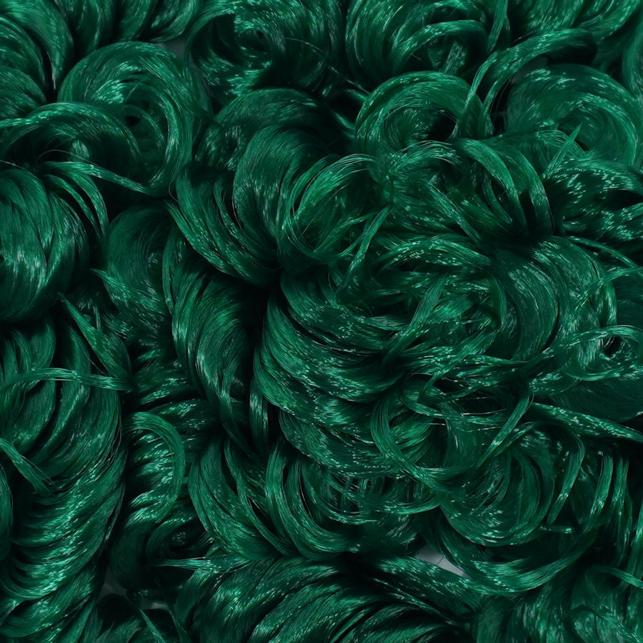 Close-up of emerald green curly nylon doll hair by Shimmer Locks showing tight, defined ringlets. Great for rerooting Barbie and Monster High dolls.