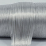 Granite Gray nylon doll hair spool by Shimmer Locks. Smooth, cool-toned stone gray fiber showing shine and texture on the roll