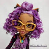 Profile shot of a custom Monster High Clawdeen doll head tightly styled Lilac Breeze light purple and Exotic Grap saran hair from Shimmer Locks. Rerooted by @hannahlectermh.