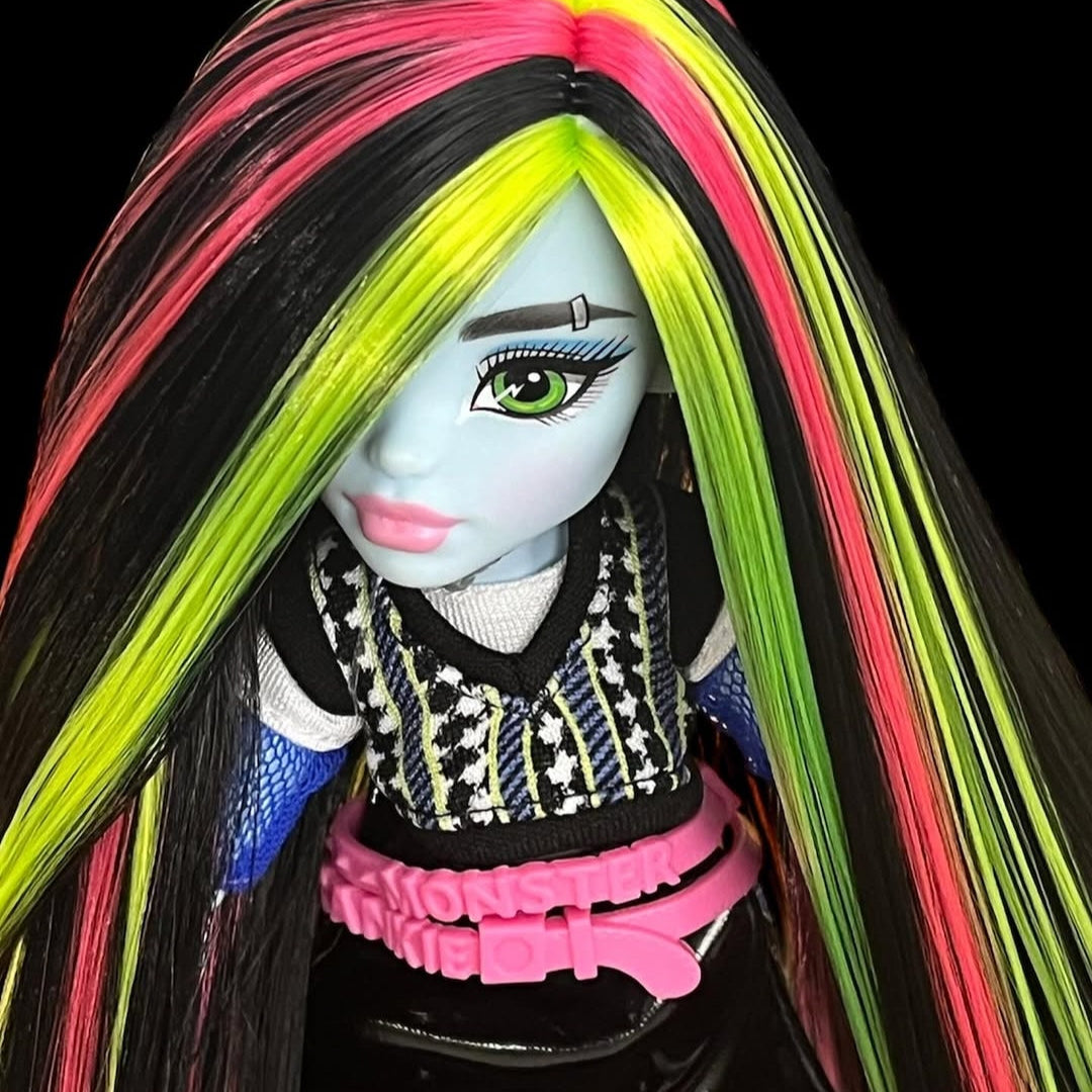 Close-up of Monster High Frankie Stein custom reroot showing a crisp side part with vibrant Pizzazz hot pink nylon hair. Rerooted by @celenasdolls.