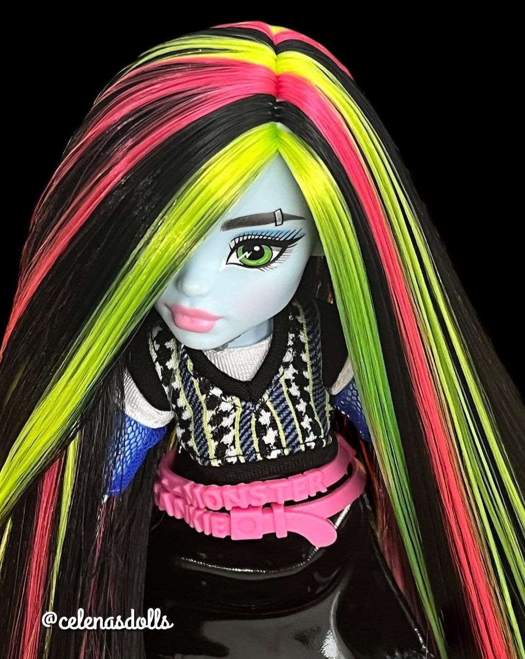 Close-up of Monster High Frankie Stein custom reroot showing a crisp side part with vibrant Pizzazz hot pink nylon hair. Rerooted by @celenasdolls.