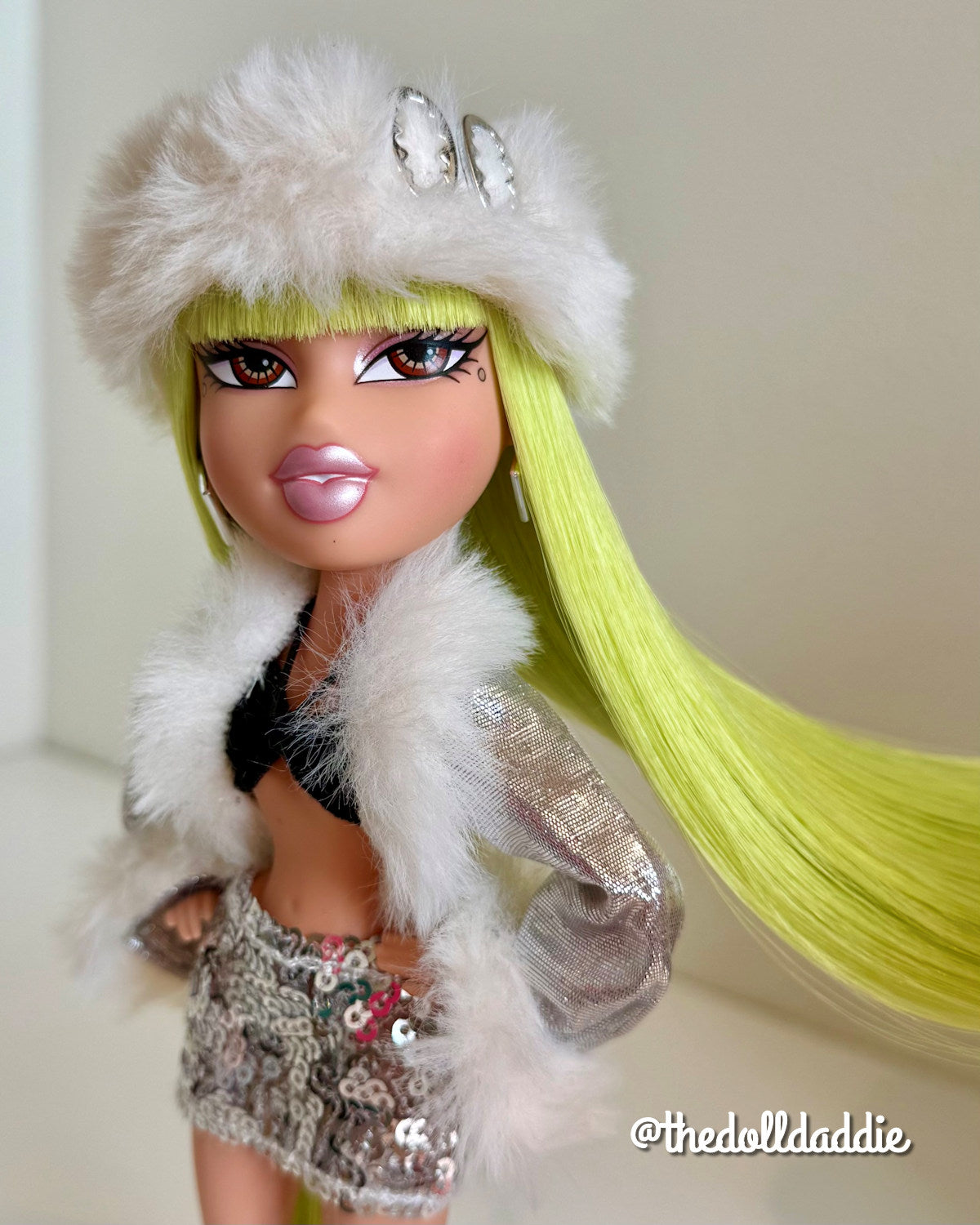 Angled dynamic shot of custom Bratz Wintertime Wonderland Jade with Shimmer Locks Radioactive neon green saran doll hair by @thedolldaddie. Highlights how direct light catches the neon fiber as the hair flows to the side.