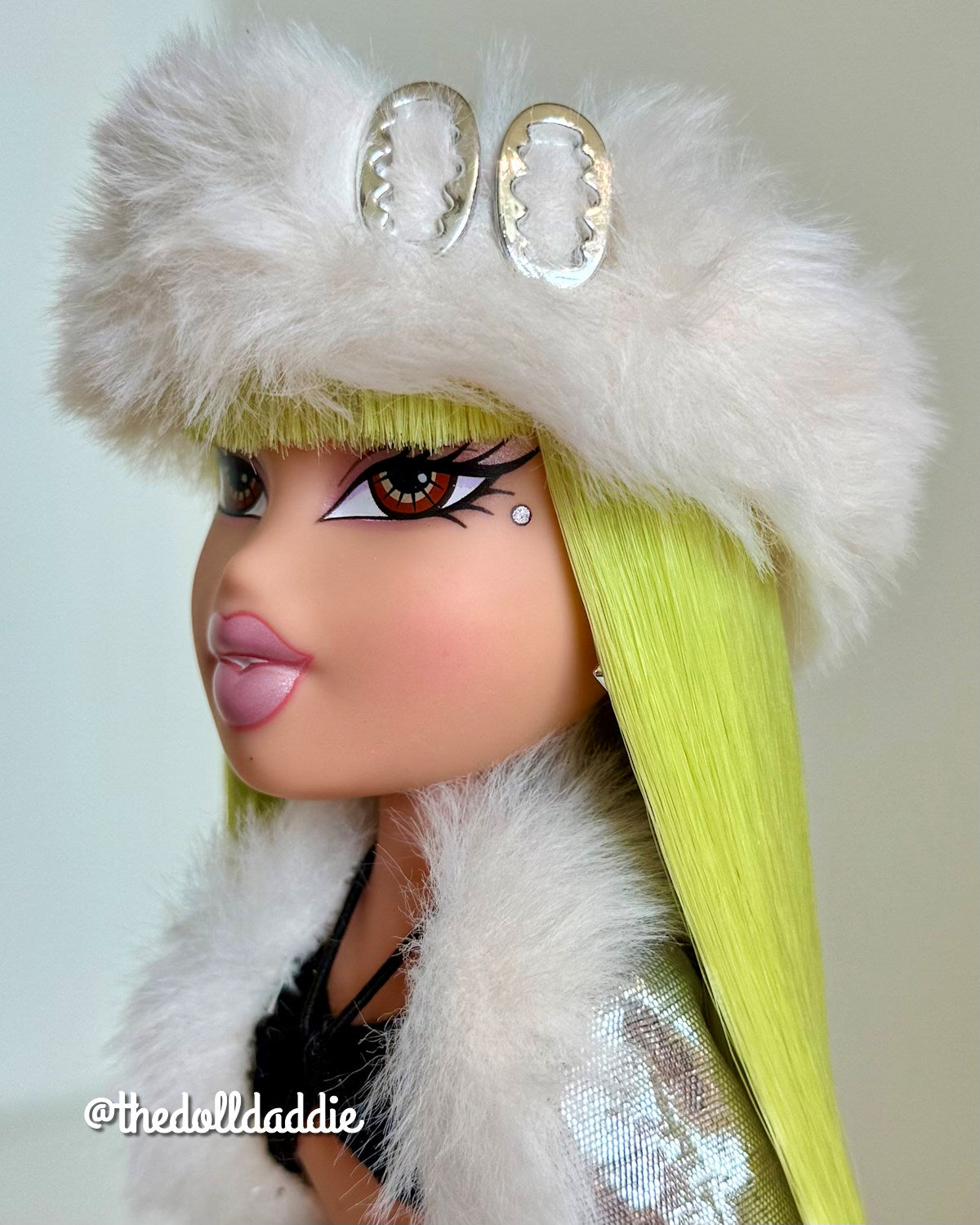 Side profile close-up of custom Bratz Wintertime Wonderland Jade featuring Shimmer Locks Radioactive neon green saran doll hair by @thedolldaddie. Highlights hairline, bangs precision, and bright fiber color vibrancy.