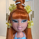 Extreme close-up custom reroot example of Safari Auburn saran doll hair on Bratz Pop Starz Jade by @thedolldaddie. Detailed portrait shot focusing on the smooth, blunt bangs, high topknot styling, and vibrant copper-red hair tone.