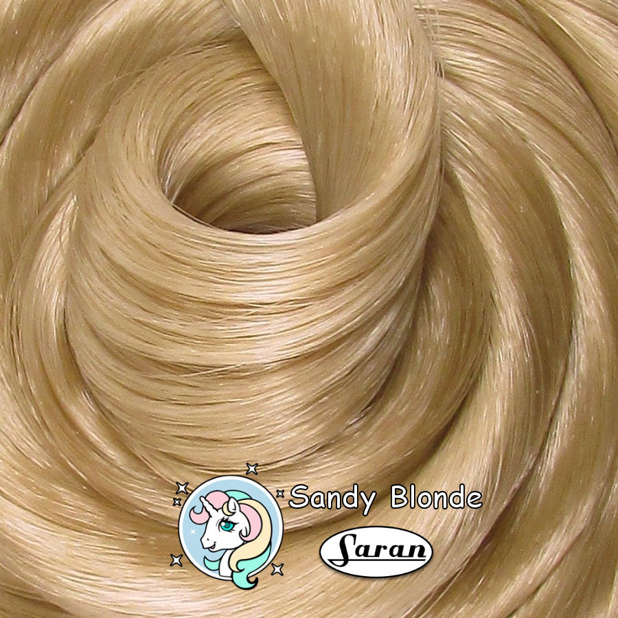 Sandy Blonde Saran doll hair by Shimmer Locks. Golden-beige blonde fiber for vintage Barbie, Takara, and Integrity Toys reroots and restorations.