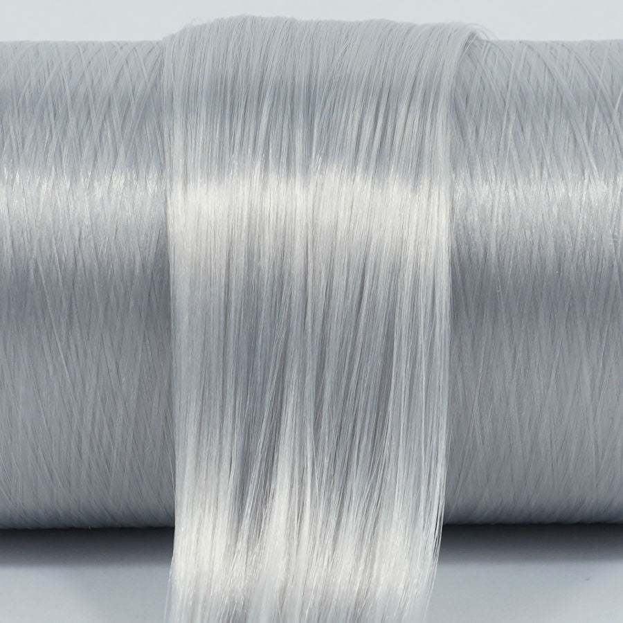 Shiver gray nylon doll hair hank laying on top of a roll.