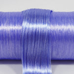 Metallic Supernova nylon doll hair spool by Shimmer Locks. Smooth, metallic indigo-violet fiber showing high-shine celestial texture on the roll.