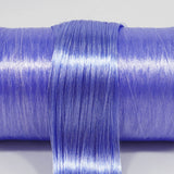 Metallic Supernova nylon doll hair spool by Shimmer Locks. Smooth, metallic indigo-violet fiber showing high-shine celestial texture on the roll.